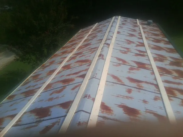Rusted metal roof panels with new wood purlins before replacement — Storm Damage Roof Repair in Eureka by Roofing Brothers