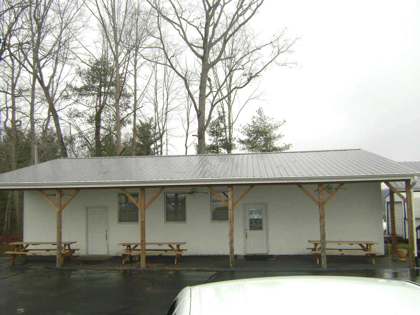 Gray metal roof over a block building with a timber post porch in Eureka